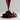 Chorro de chocolate cayendo sobre un montón de pasas oscuras, resaltando el proceso artesanal de Mysuplify.